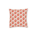 A square throw pillow featuring a repeating pattern of red strawberries with green tops on a light pink background, shown against a plain white studio backdrop.